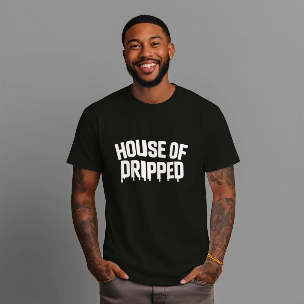 A smiling man wearing a black House of Dripped heavyweight cotton streetwear t-shirt with white logo graphic.